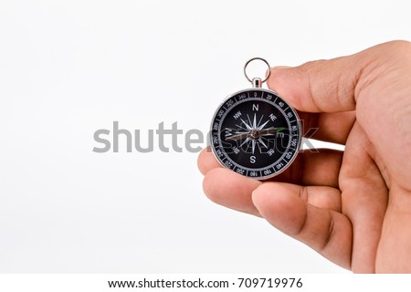  Compass in hand on white background.Selective focus.