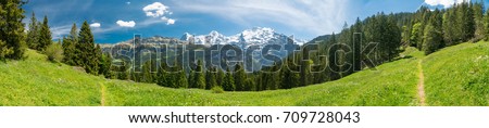 Spectacular mountain views and hiking trail in the Swiss Alps landscape near Stechelberg the district of Lauterbrunnen, Switzerland Royalty-Free Stock Photo #709728043