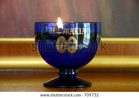 A glass goblet candle for prayer offering in a church