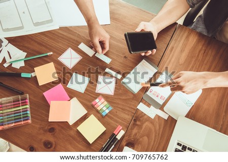 Teamwork and programming websites and mobile applications on the phone, so-called. user experience (UX). Web designer, UX UI designer planning application for mobile phone.