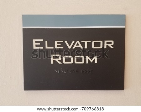 elevator room sign with Braille