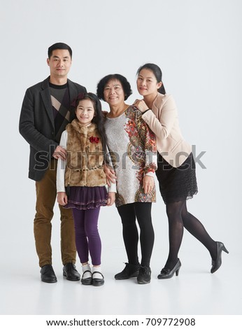 Family portrait of young Asian parents, daughter, grandmother. shot in studio white background