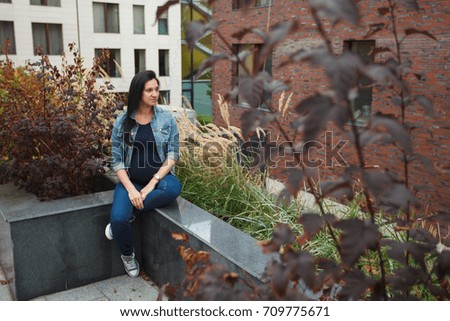 Happy young smiling pregnant woman resting sitting