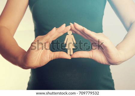 Wood woman icon in woman hands - Happy family concept.