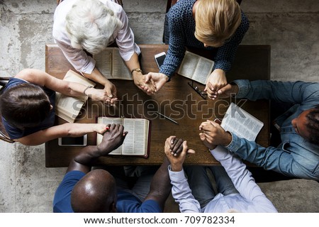 Group of people holding hands praying worship believe Royalty-Free Stock Photo #709782334