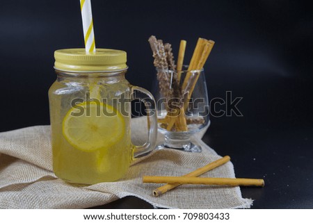 lemonade with iced  and snack on dark background
