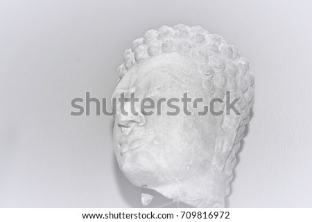 Part of the face of the Buddha made of sandstone. Black and white picture. This image was blurred  