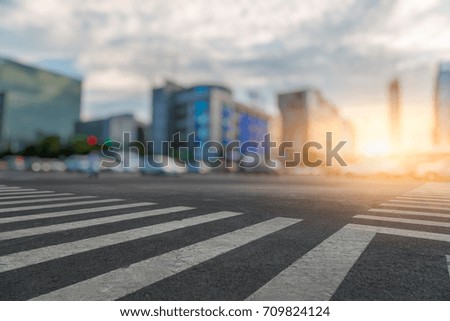empty road with zebra crossing and skyscrapers in modern city
