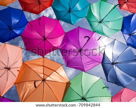 Summer sunshine and blue sky decorated with colorful umbrellas on the street  of tourist city in Asia
