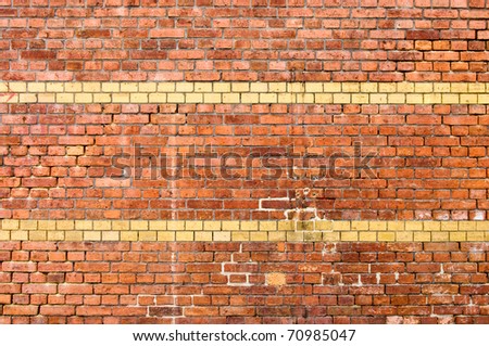 Old yellow striped brick wall