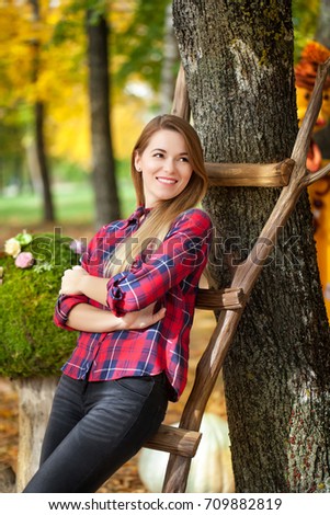 Smiling girl in the autumn park