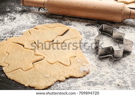 Raw dough for Christmas cookies on table