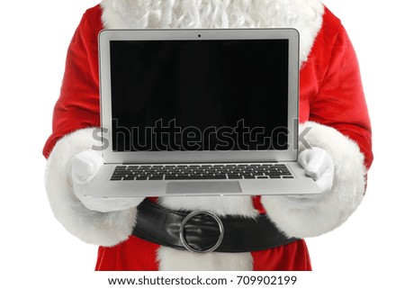 Santa Claus holding laptop on white background