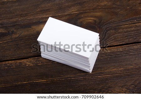 Blank business cards on the wooden table. Template for ID. Top view