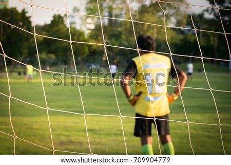 The football net with player on background, net goal of football and blurred player.