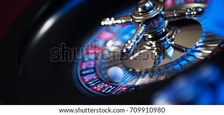 Roulette in casino and Poker Chips Royalty-Free Stock Photo #709910980