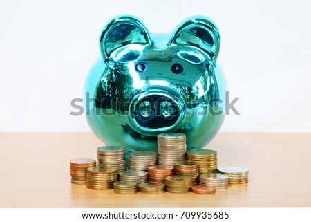 Saving money in piggy bank.