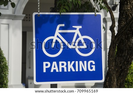The image of bicycle sign blue color at the gasoline station.