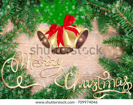 Christmas card. Christmas bells with fir branches are on a wood board background