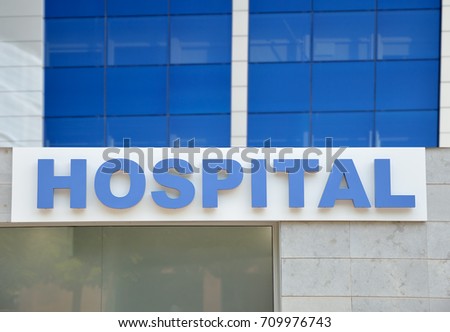Hospital building sign closeup, with sky reflecting in the glass. 3d rendering