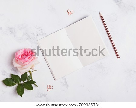 Notepad template on marble background, top view.