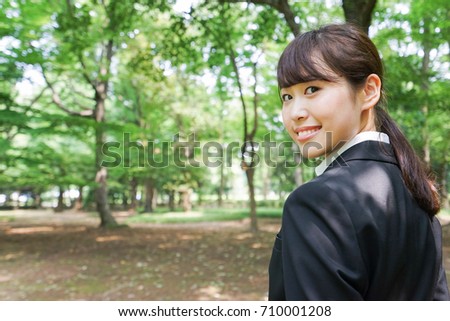Young business woman smiling with suit