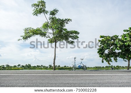 folding bike parked at side road,sky background