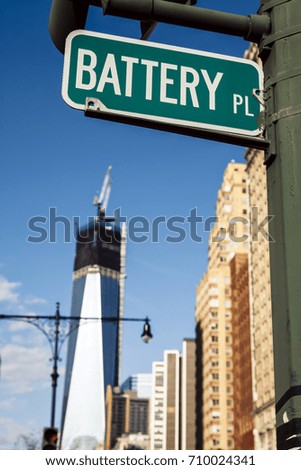 NEW-YORK - NOV 9: A street sign depicting it is Battery Place in Manhattan, and the 1WTC under contruction in the background on November 9, 2012 in New-York, USA.