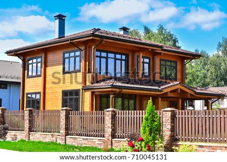 Photo of beautiful modern wooden house.