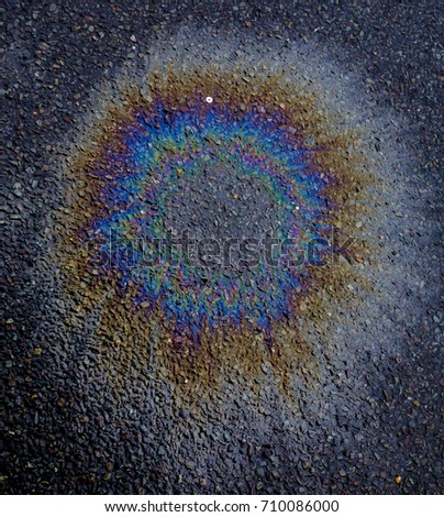 Metallic Rainbow Petrol Spill on Pavement Sidewalk