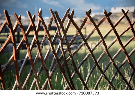 Wooden fence in the highlands and blue sky with clouds