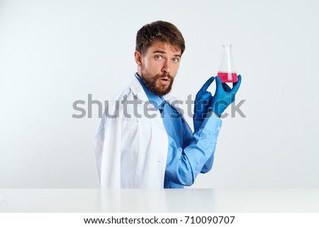doctor with a bulb looks at the camera
                               