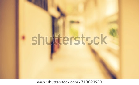 Abstract blur image of  long corridor with bokeh for background usage . (vintage tone)