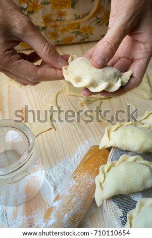 Ukrainian traditional bakery products - Making pierogies by female hands. Rustic style. Retro Photo
