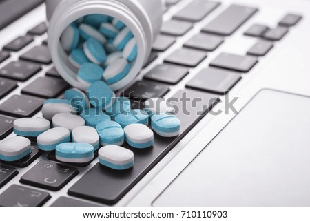 Close up of pills on a laptop, Healthy and hard work concept. Selective focus