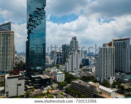 Top view aerial shot of the city with skyscrapers, business centers and towers against cloudy sky