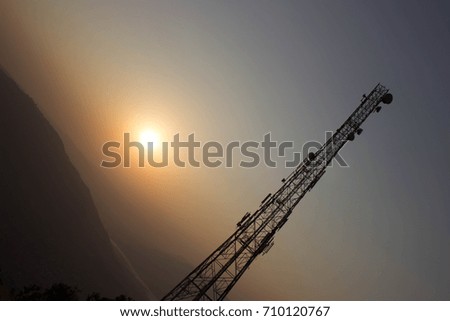 Communication tower with sun at the backdrop Royalty-Free Stock Photo #710120767