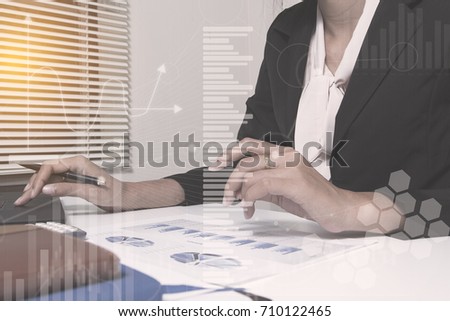 Investment manager working new private banking project office. Use laptop with graphic data