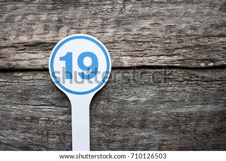 Plate number on a old wooden background. Numbers for lists or numbering concept. 