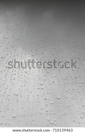 Raindrop on glass of window in abstract background