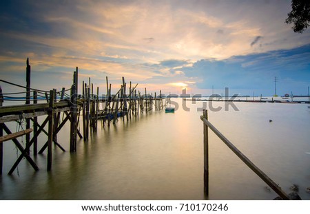 Beautiful long exposure sunrise shot at jetty. Image contain certain grain or noise and soft focus when view at full resolution