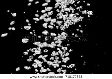 Air bubbles on a black background.