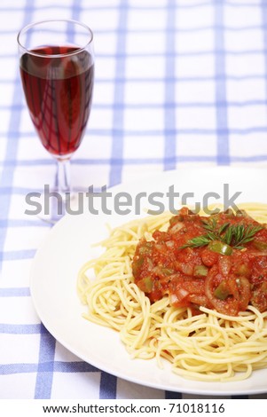 A picture of fresh spaghetti with red wine on the table