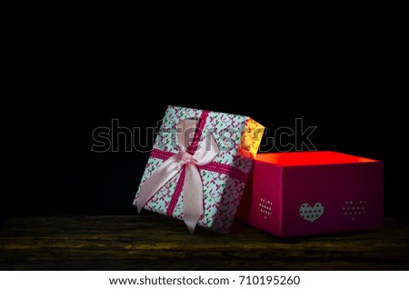 Pink gift box on black background and copy space.
