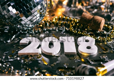 A series celebrating New Year's Eve, some with 2018 numerals.  Lots of confetti, champagne, etc. Good for background of ads. Royalty-Free Stock Photo #710198827