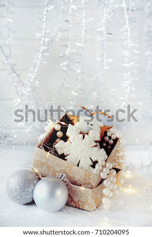Magical winter christmas picture. Gingerbread cookies and  new year toys and decorations in paper box.