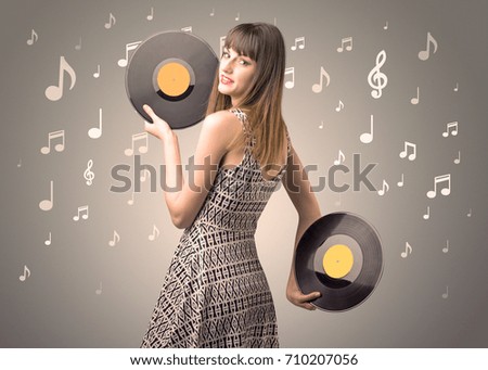 Young lady holding vinyl record on a brown background with musical notes behind her