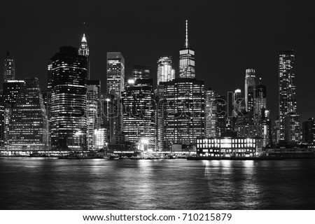 Black and white picture of Manhattan skyline at night, New York City, USA.