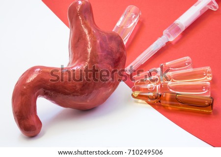Scene of treating, cure or vaccination against diseases of stomach - acute and chronic. Anatomical model of stomach or gastric is located opposite vials and syringe with medication on red background