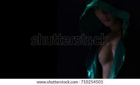 Portrait man in the hood or hooligan over dark background background with copy space , halloween ghost  concept